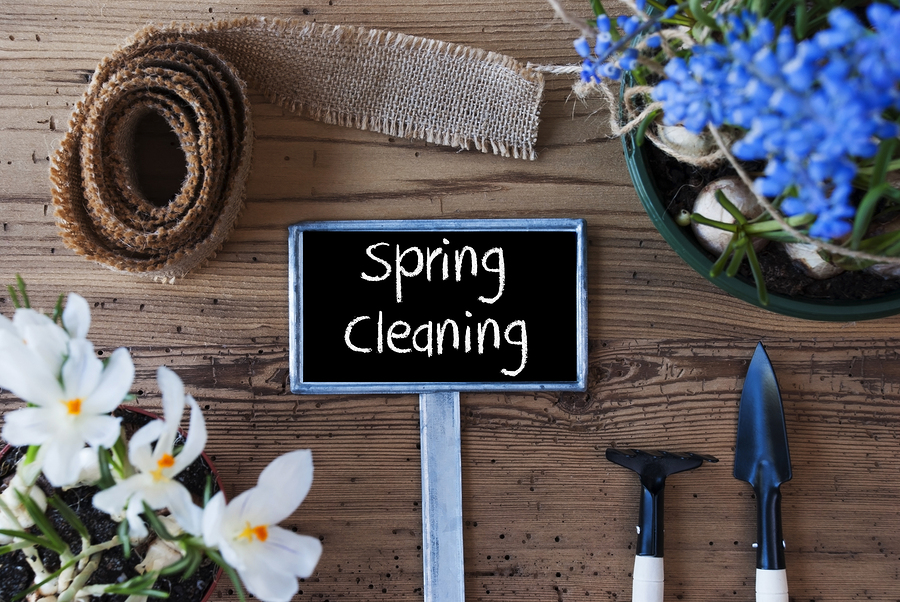Spring cleaning sign with tools and flowers