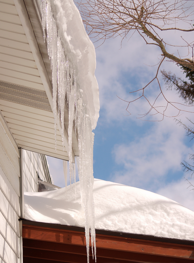 Icicles and snow covered roof creating an ice dam
